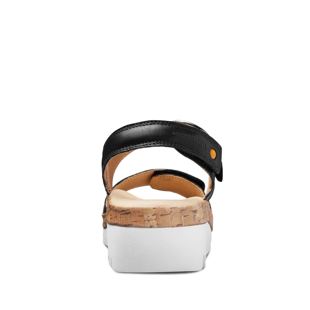 Black sandal with cork insole on a white background